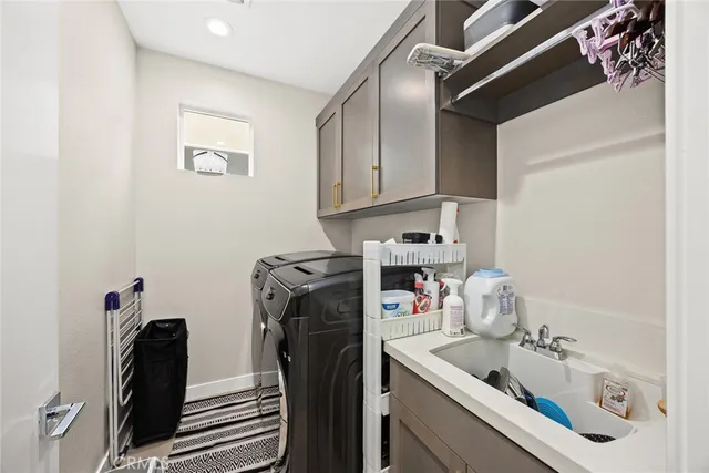 a bedroom with a bed and a couch next to a window