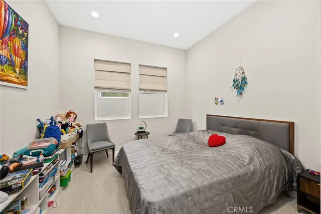 a bedroom with a large bed and a large window