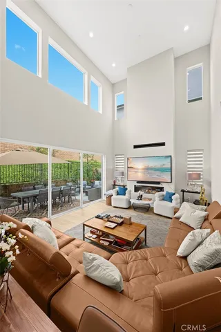 a living room with furniture a large window and a view of bedroom