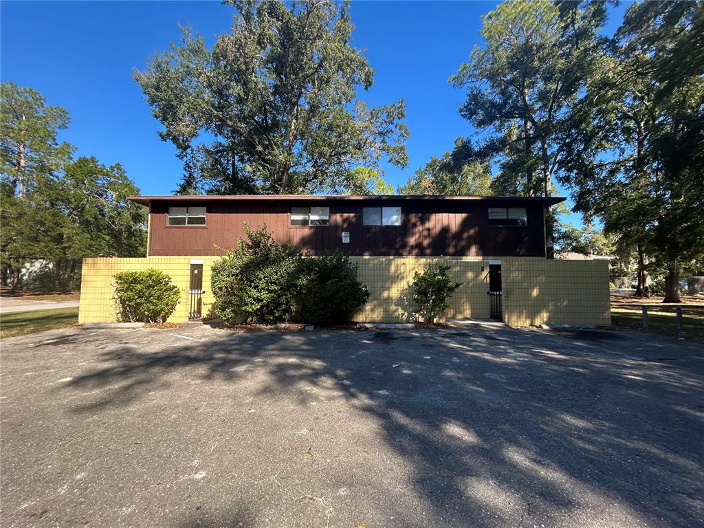 707 Southwest 68th Terrace, Unit B Gainesville, FL 32607 - Photo 1 of 12 a backyard of a house with lots of green space