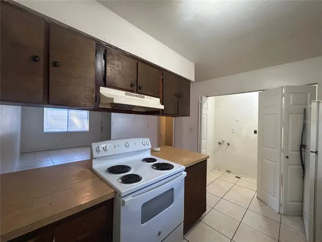 a kitchen with a stove and a refrigerator