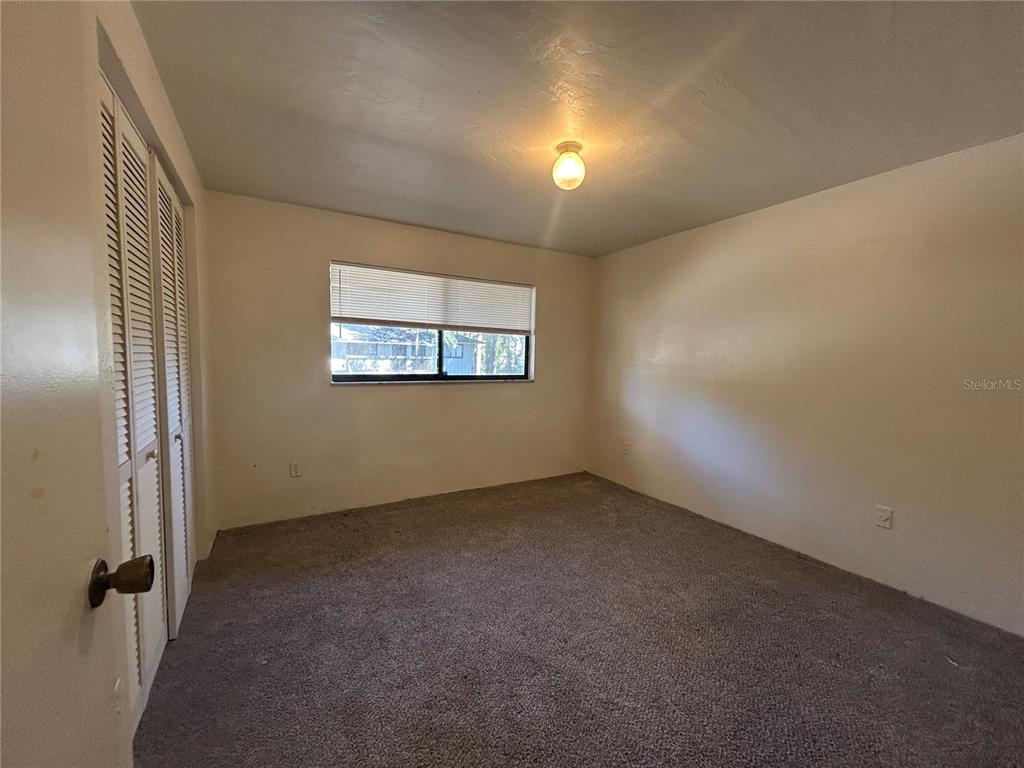 707 Southwest 68th Terrace, Unit B Gainesville, FL 32607 - Photo 9 of 12 an empty room with windows