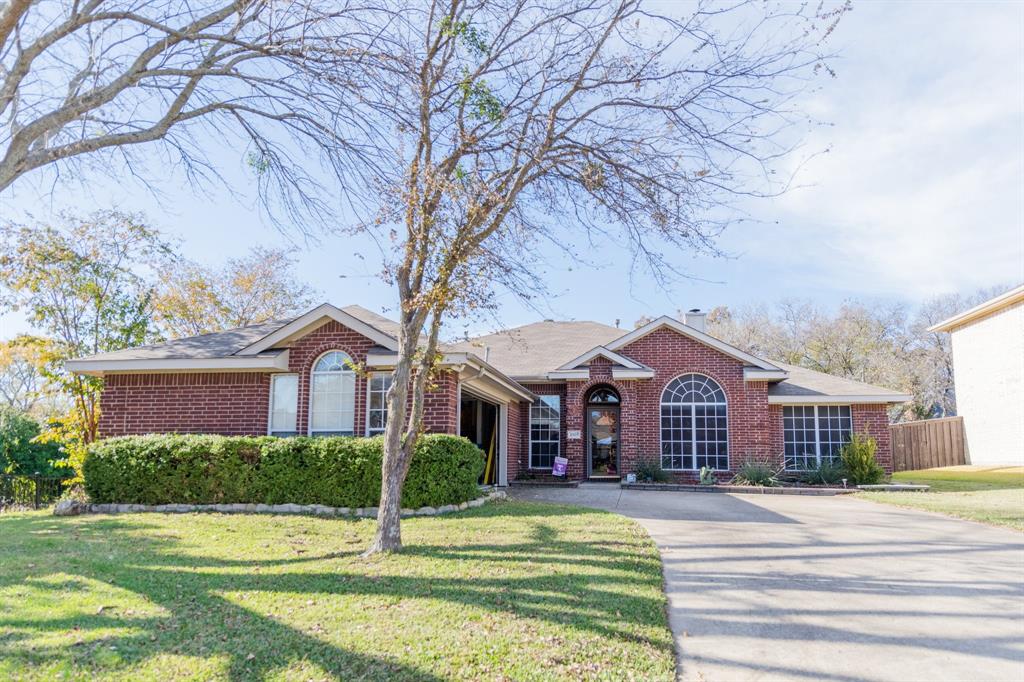2107 Lacebark Lane Rockwall, TX 75087 - Photo 1 of 34 a view of a house with a yard and large tree and plants