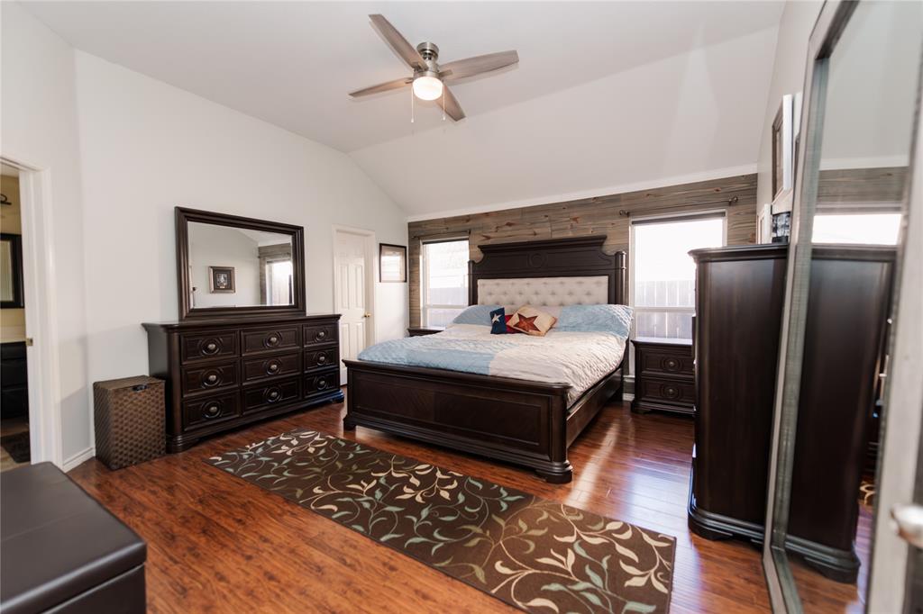 2107 Lacebark Lane Rockwall, TX 75087 - Photo 11 of 34 a bedroom with a bed and wooden floor