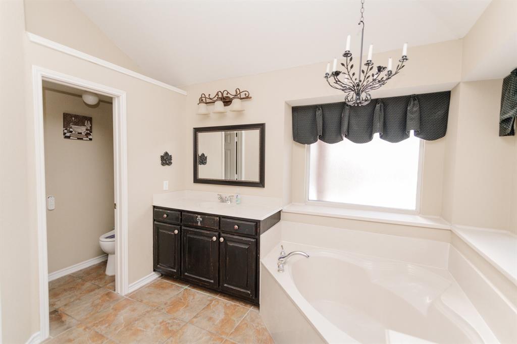 2107 Lacebark Lane Rockwall, TX 75087 - Photo 12 of 34 a spacious bathroom with a tub sink and mirror