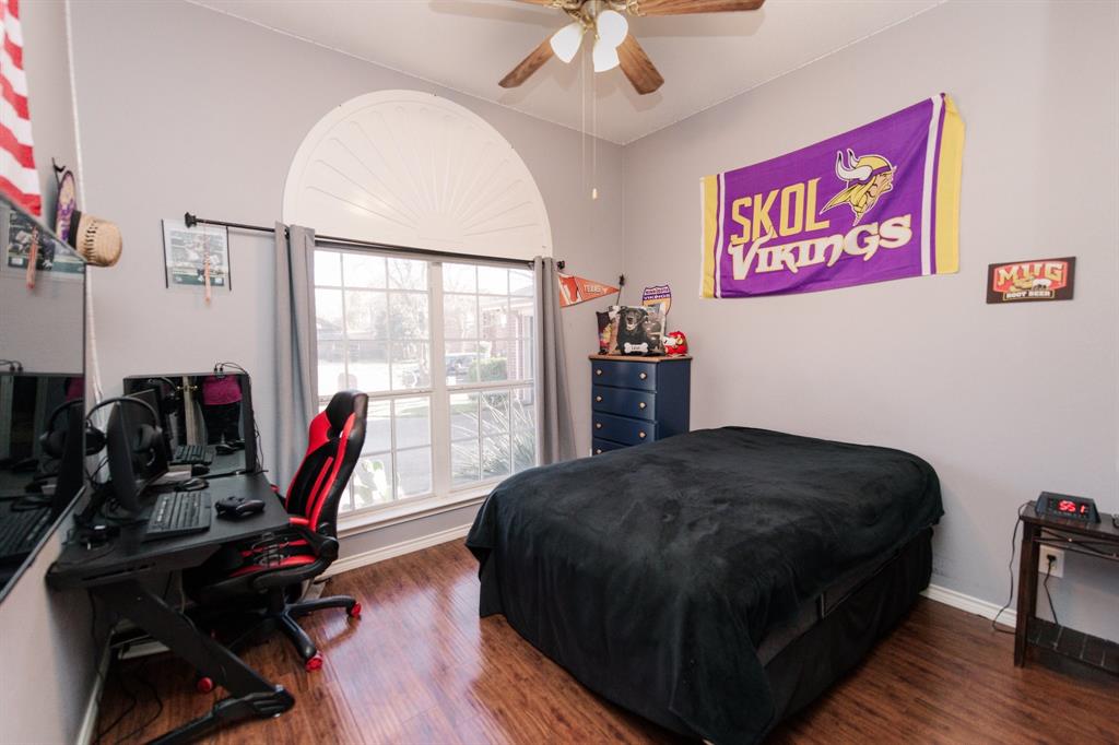 2107 Lacebark Lane Rockwall, TX 75087 - Photo 14 of 34 a bedroom with a bed and a wooden floor