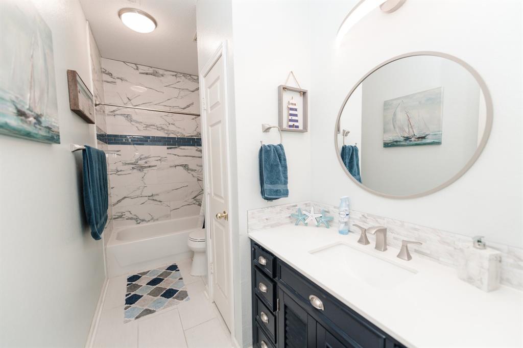 2107 Lacebark Lane Rockwall, TX 75087 - Photo 17 of 34 a bathroom with a sink vanity and a mirror