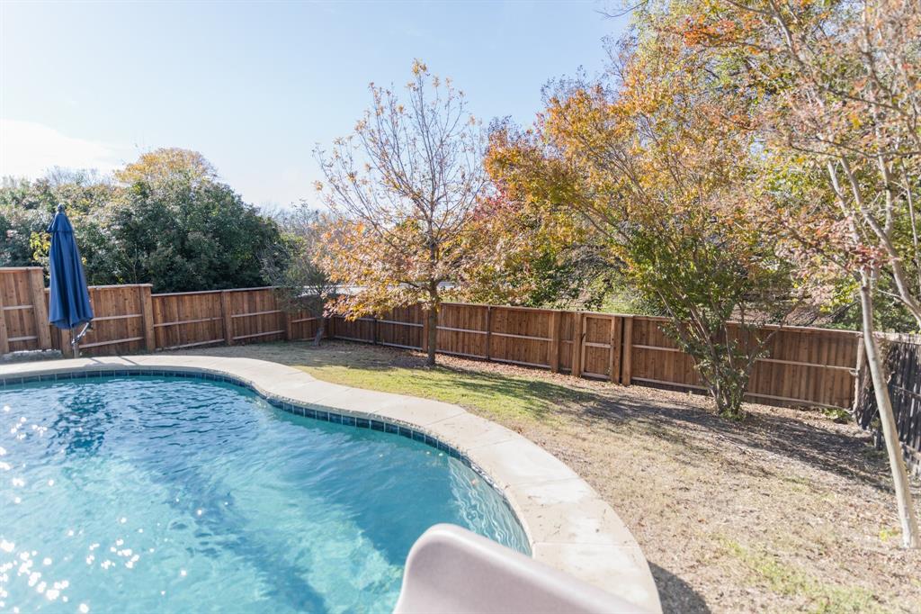 2107 Lacebark Lane Rockwall, TX 75087 - Photo 26 of 34 a swimming pool with wooden fence