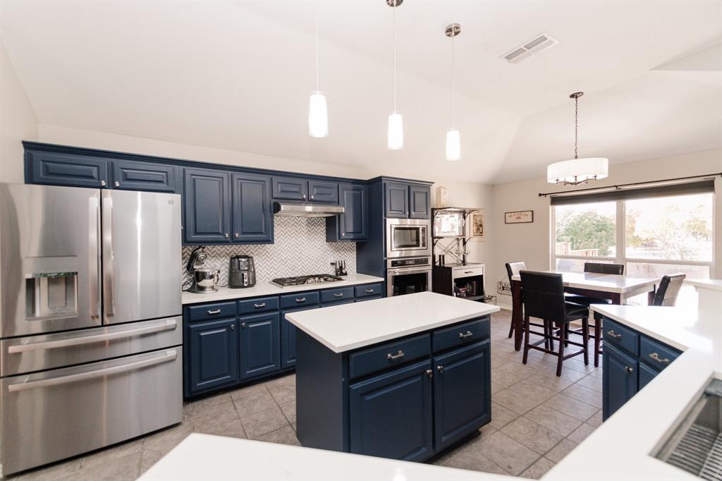 2107 Lacebark Lane Rockwall, TX 75087 - Photo 7 of 34 a kitchen with stainless steel appliances granite countertop a sink a stove and a refrigerator