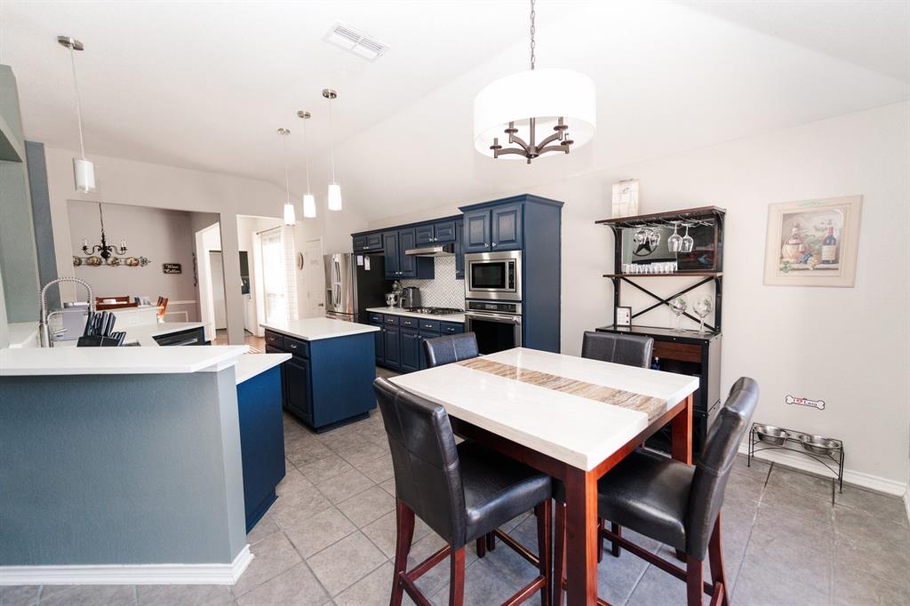 2107 Lacebark Lane Rockwall, TX 75087 - Photo 9 of 34 a large kitchen with a table and chairs