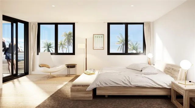 a bedroom with a large bed and a window