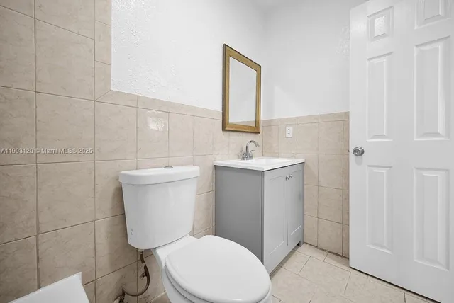 a white toilet sitting next to a bathroom sink