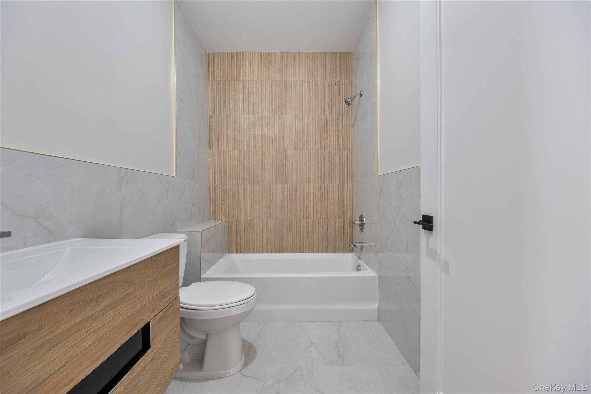17 Lazer Court, Unit 102 Spring Valley, NY 10977 - Photo 26 of 31 Full bathroom with vanity, shower / tub combination, and tile walls
