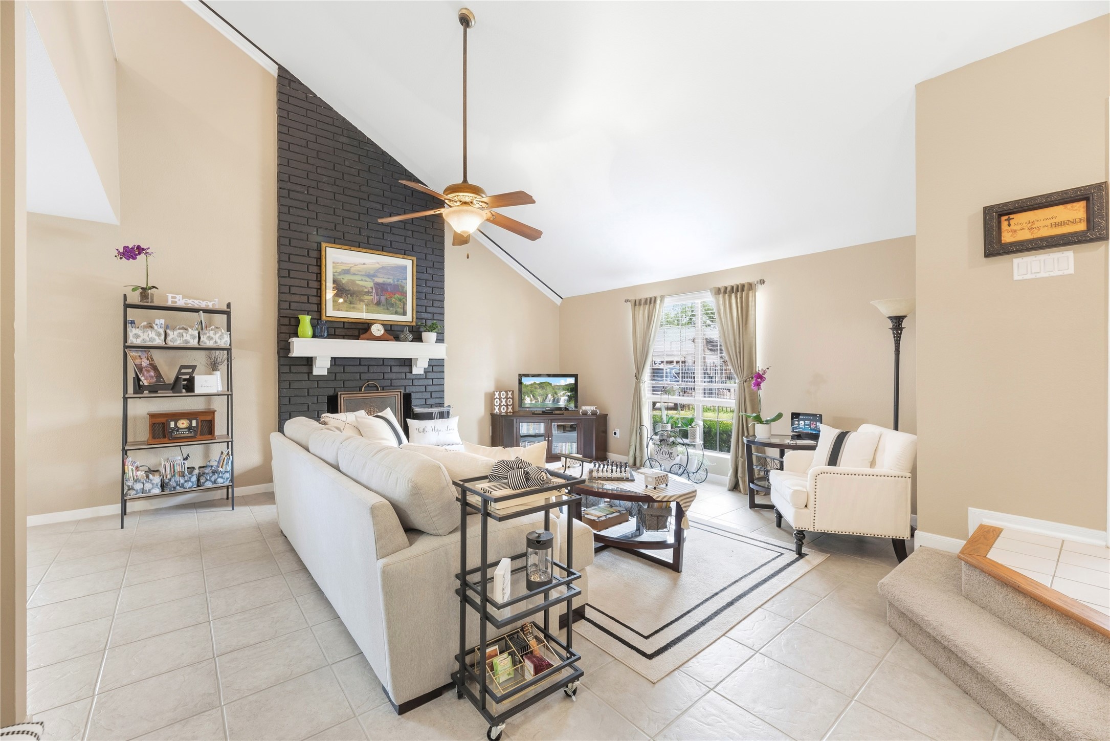 16913 Chapel Pines Drive, Unit 126 Spring, TX 77379 - Photo 4 of 27 This living room features high vaulted ceilings, a cozy fireplace with a dark accent wall, and large windows that provide ample natural light.