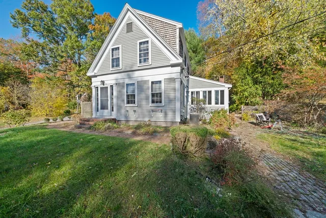 a view of a house with yard and sitting area