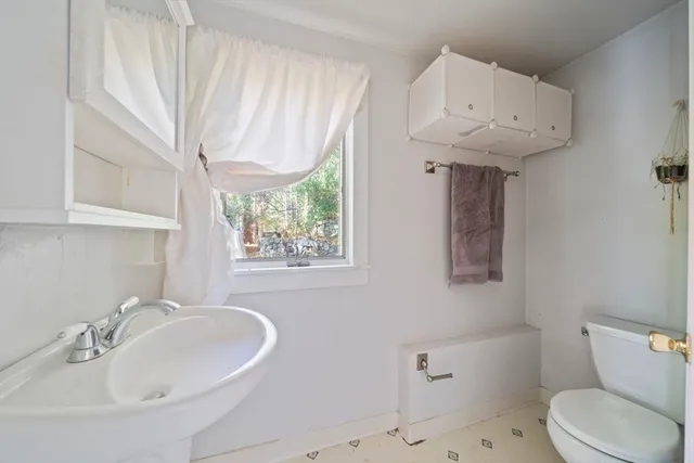 a bathroom with a sink a toilet and bathtub