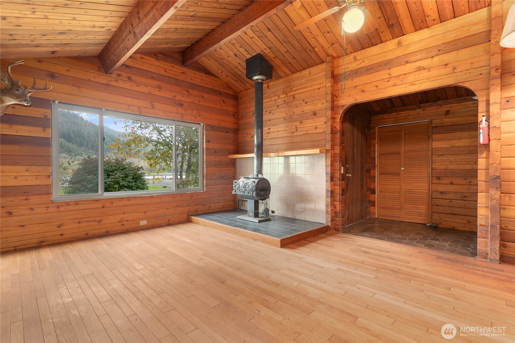 5950 Truck Road Deming, WA 98244 - Photo 6 of 23 a view of empty room with wooden floor and floor to ceiling window