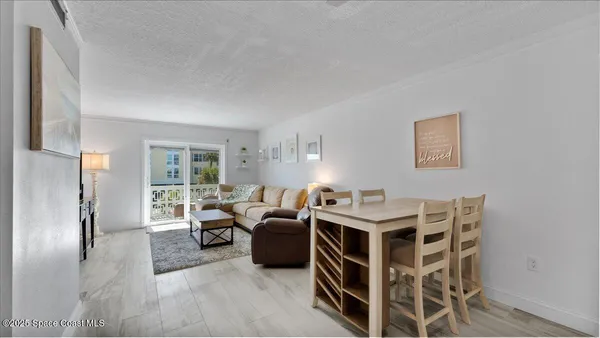 a balcony with table and chairs