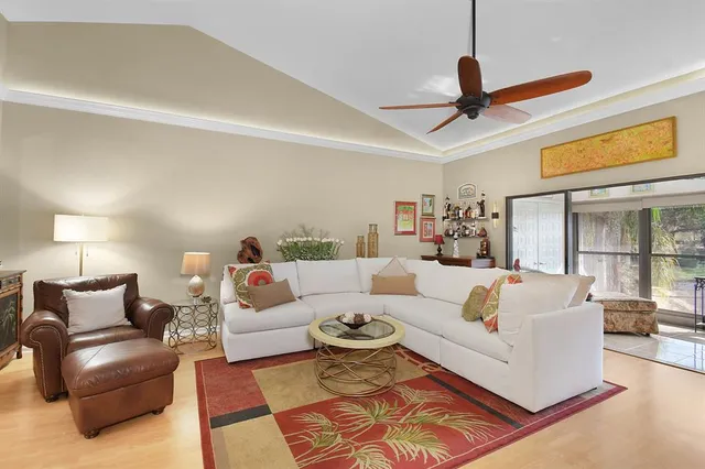 a living room with furniture and a ceiling fan