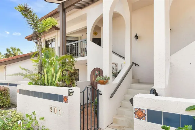 a kitchen with stainless steel appliances granite countertop a sink refrigerator and cabinets