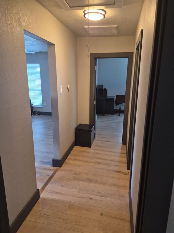 815 Bonnie View Road Dallas, TX 75203 - Photo 10 of 29 Hall with light wood-type flooring and attic access