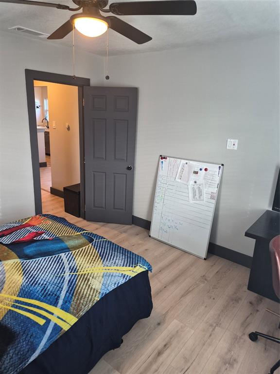 815 Bonnie View Road Dallas, TX 75203 - Photo 13 of 29 Bedroom featuring light wood-type flooring, ceiling fan, and an office area