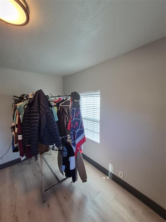 815 Bonnie View Road Dallas, TX 75203 - Photo 18 of 29 Bedroom with light wood finished floors and a textured ceiling