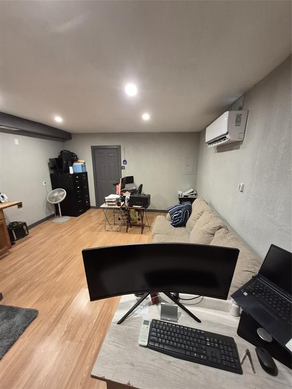 815 Bonnie View Road Dallas, TX 75203 - Photo 24 of 29 Living room with light wood-type flooring, a desk, a wall mounted AC, and recessed lighting