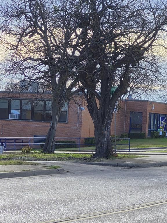 815 Bonnie View Road Dallas, TX 75203 - Photo 28 of 29 View of home's exterior featuring brick siding and a fenced front yard
