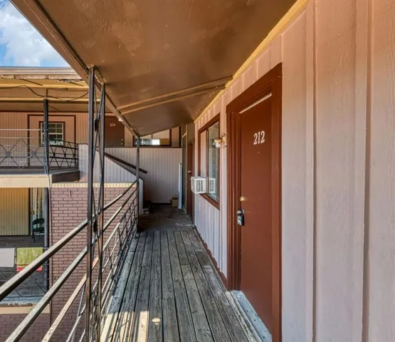 a view of a balcony with wooden floor