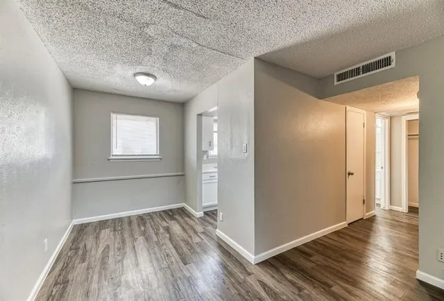 a view of a room with wooden floor and window
