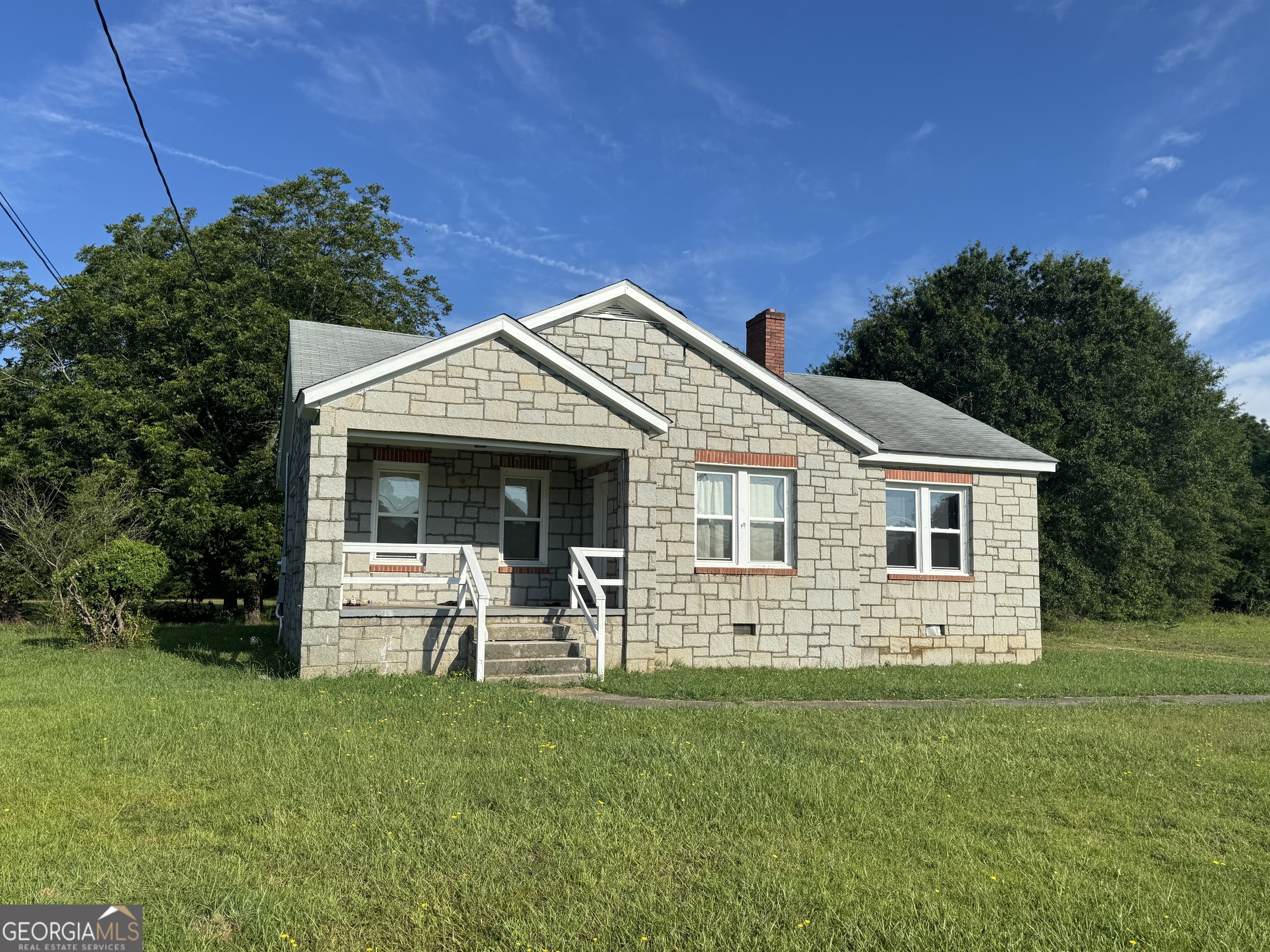 a front view of a house with a garden