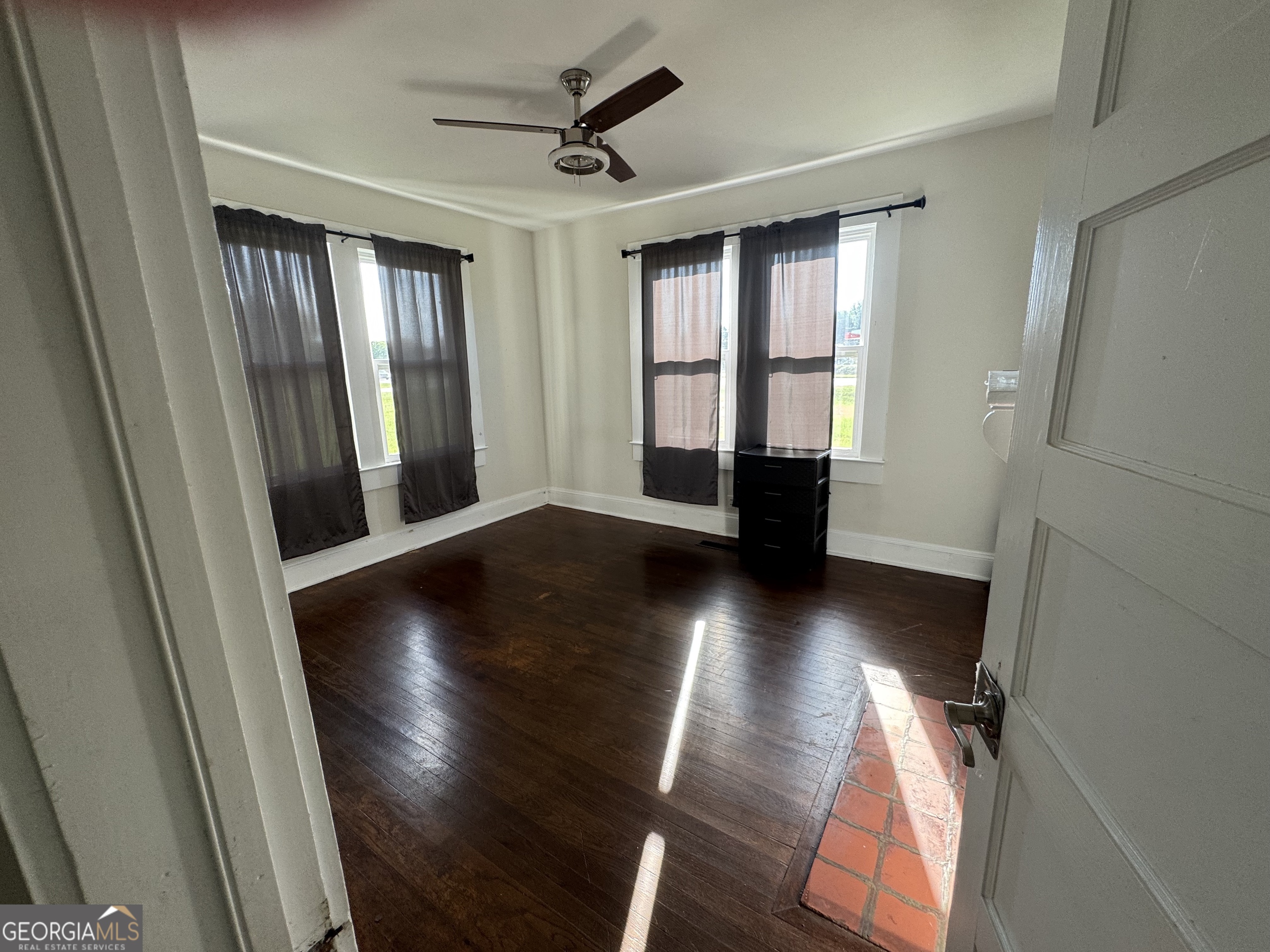 968 Elbert Street Elberton, GA 30635 - Photo 6 of 10 a view of empty room with wooden floor and fan
