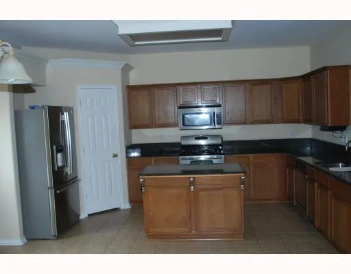 a kitchen with stainless steel appliances a refrigerator and a stove