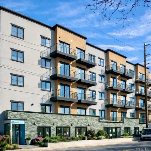 a bricked building with multiple windows and entryway