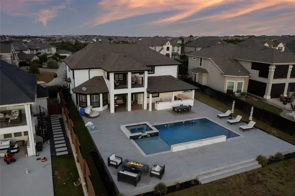 an aerial view of a house with a yard