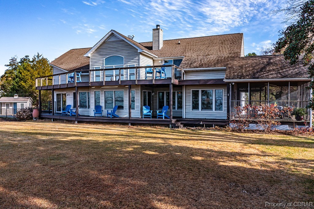 362 Beach Creek Road Lancaster, VA 22503 - Photo 2 of 47 Back of house with a balcony, a sunroom, and a lawn