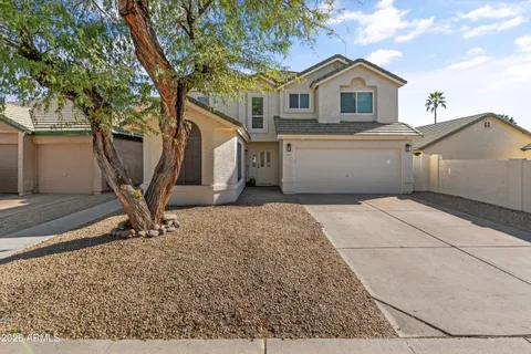a view of a house with a backyard