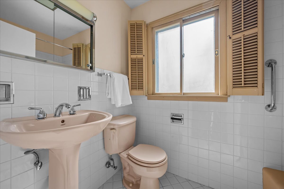 1505 Hackberry Road Deerfield, IL 60015 - Photo 13 of 19 a bathroom with a sink and mirror with toilet