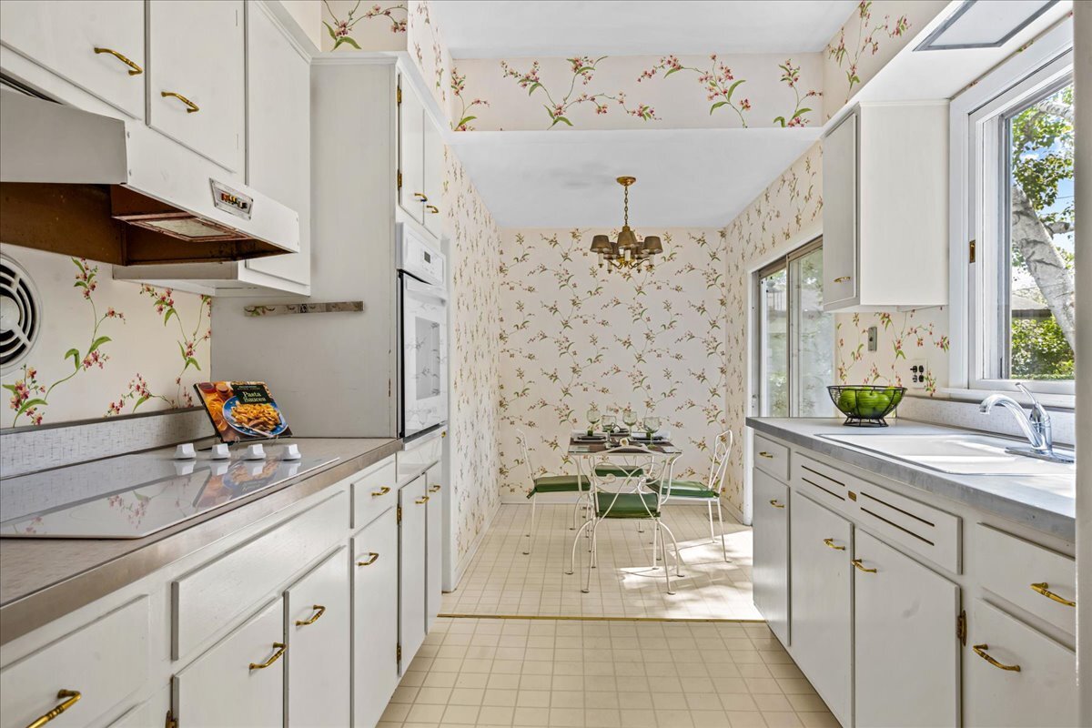 1505 Hackberry Road Deerfield, IL 60015 - Photo 5 of 19 a kitchen with stainless steel appliances a white cabinets a stove a sink and a window