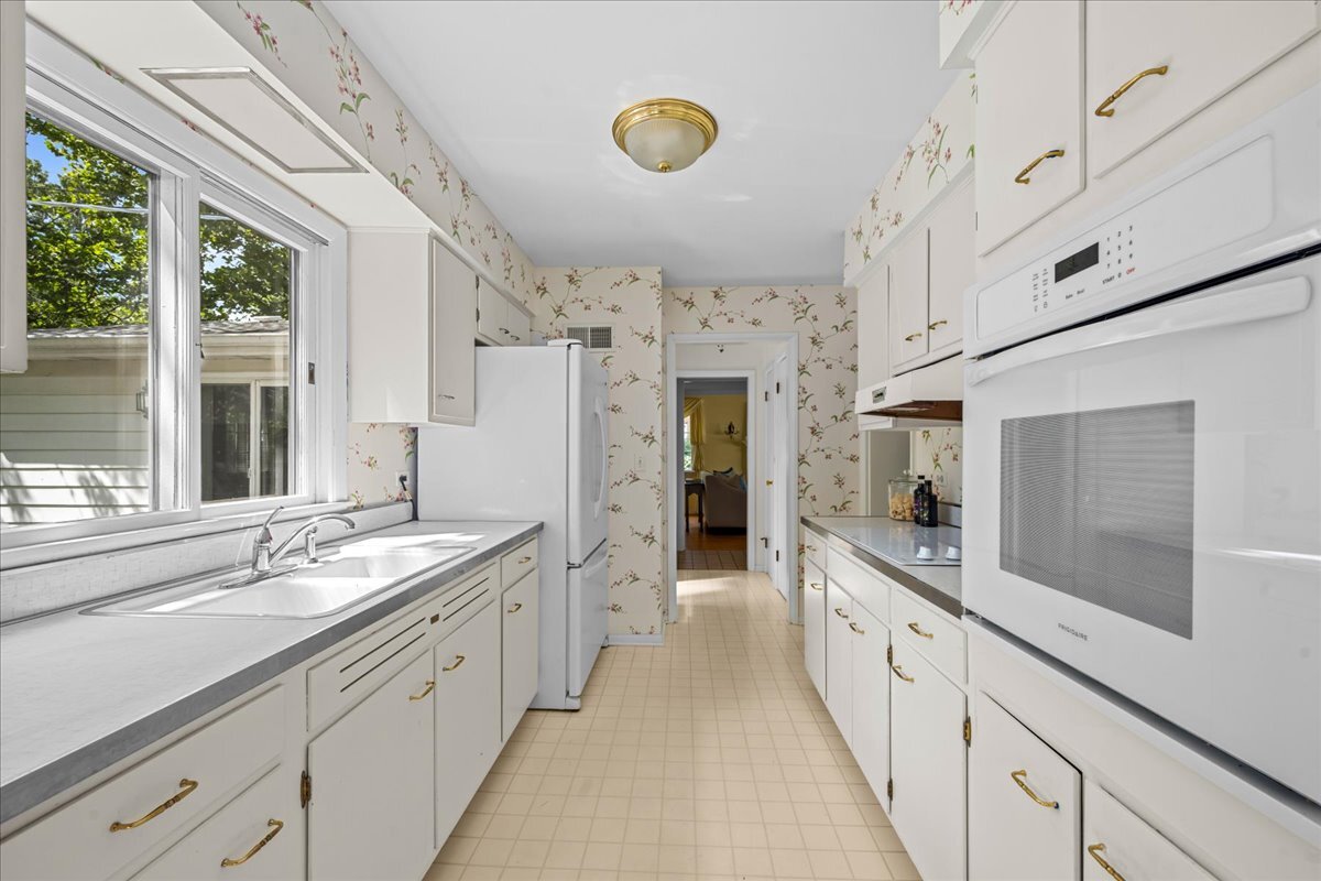 1505 Hackberry Road Deerfield, IL 60015 - Photo 6 of 19 a large white kitchen with a large window and stainless steel appliances