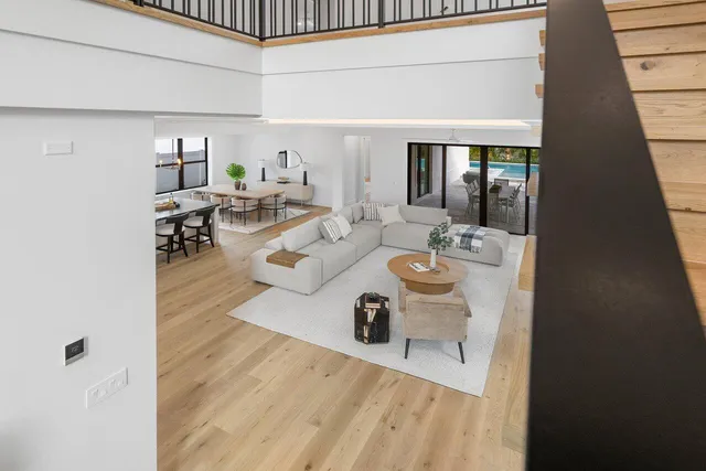 a view of a room with wooden floor