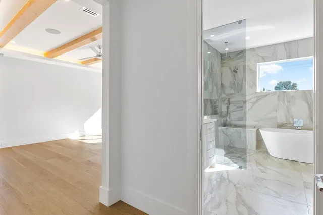 a bathroom with a toilet tub and shower
