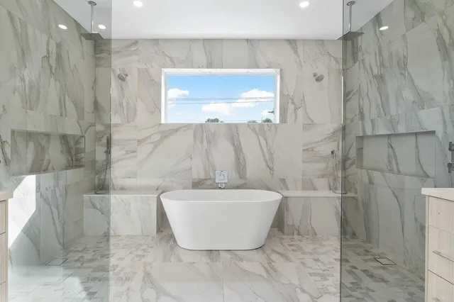 a white bath tub sitting next to a window