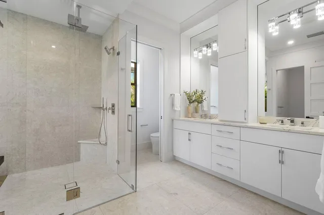 a bathroom with a shower a toilet and sink