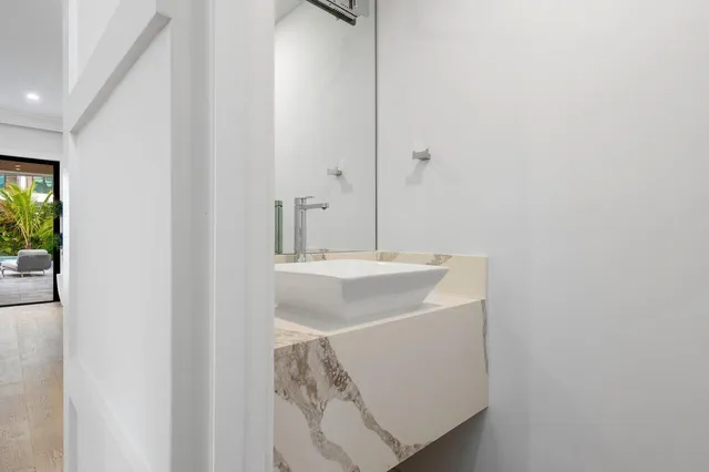 a bathroom with a sink toilet vanity and shower