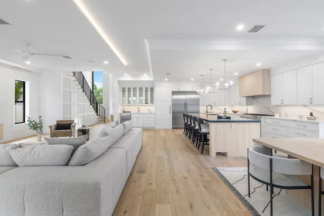 a kitchen with kitchen island granite countertop a sink and refrigerator