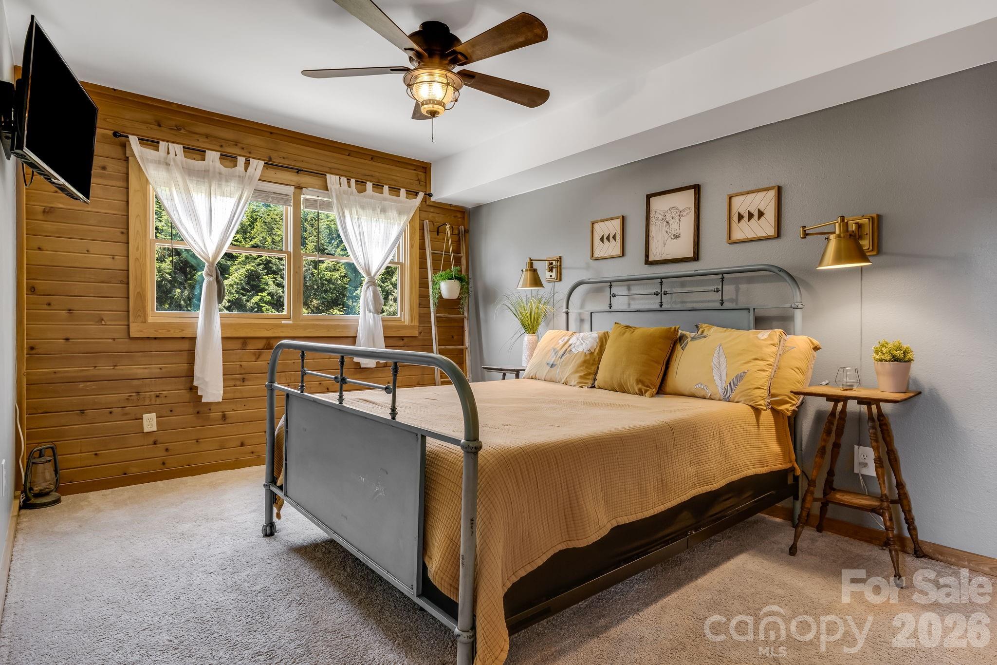694 Boulder Road Marshall, NC 28753 - Photo 16 of 44 a bed sitting in a spacious bedroom next to a window