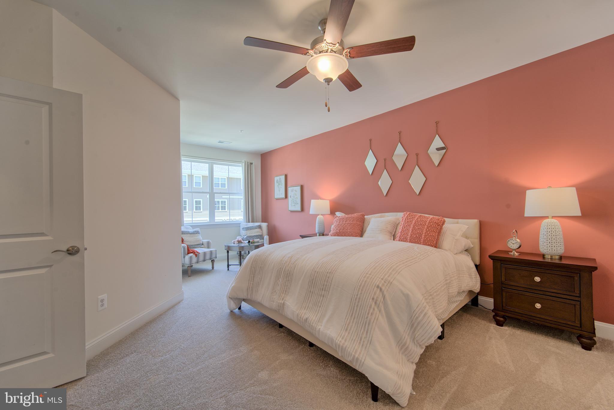 404 Bold Ruler Court, Unit 201 Havre de Grace, MD 21078 - Photo 14 of 43 a bedroom with a bed a chandelier and a window