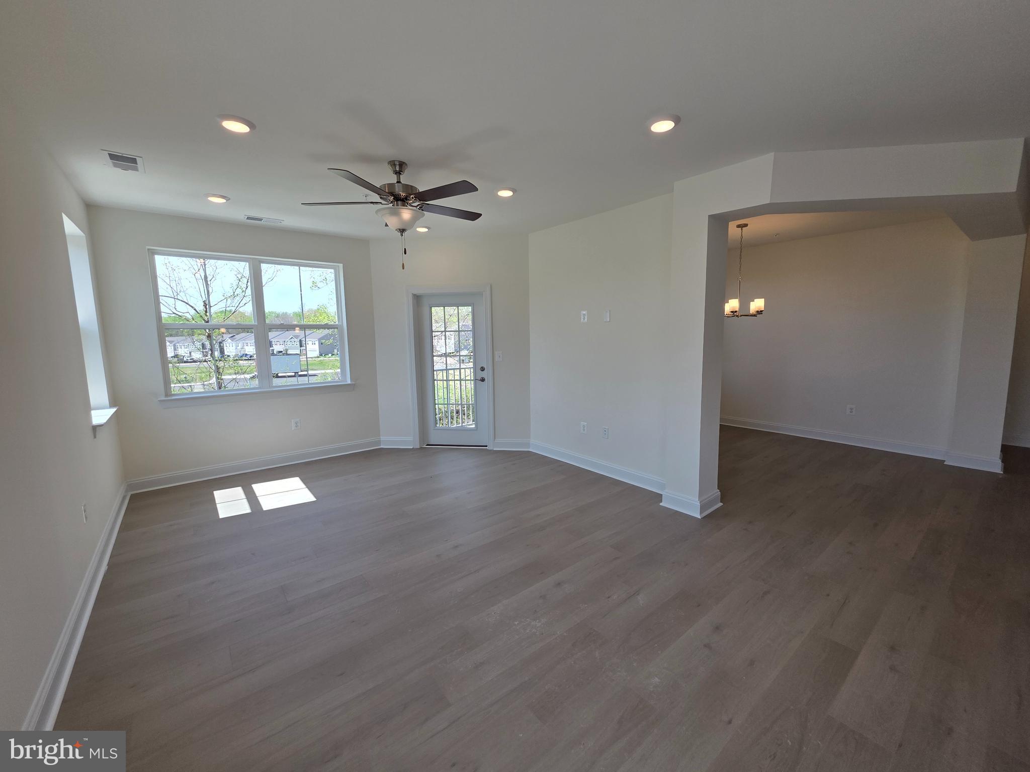 404 Bold Ruler Court, Unit 201 Havre de Grace, MD 21078 - Photo 28 of 43 a view of an empty room with a window and wooden floor
